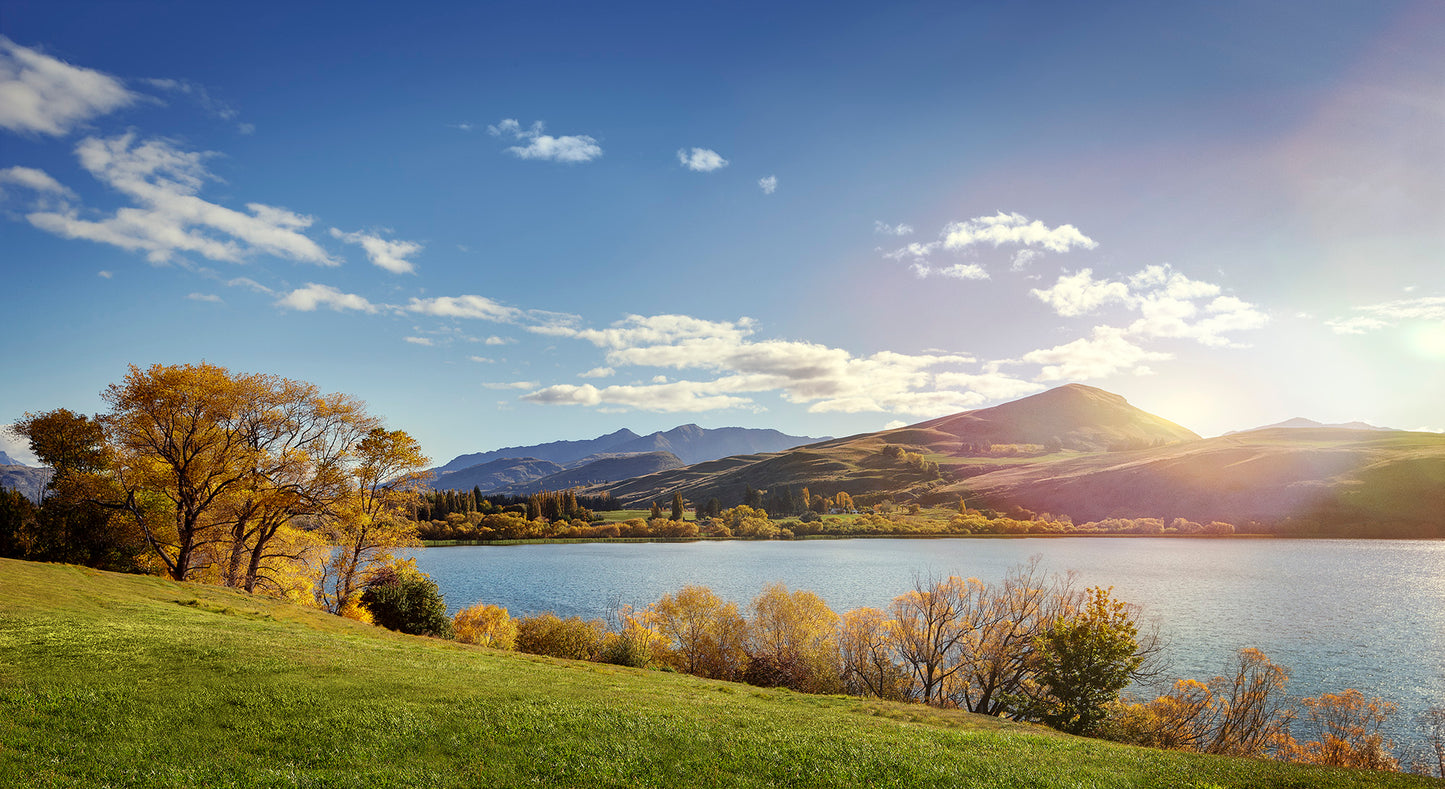 Scenic Arrowtown countryside with rolling hills, golden fields and evening light