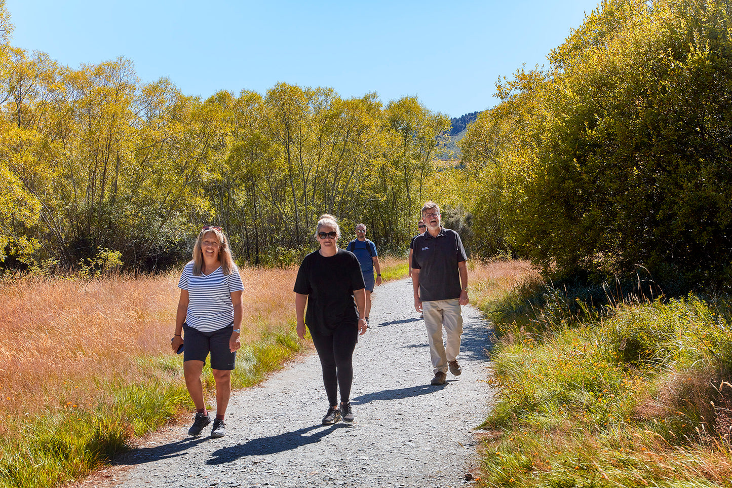 Visitors walking the Glenorchytrack with local guide on private day trip