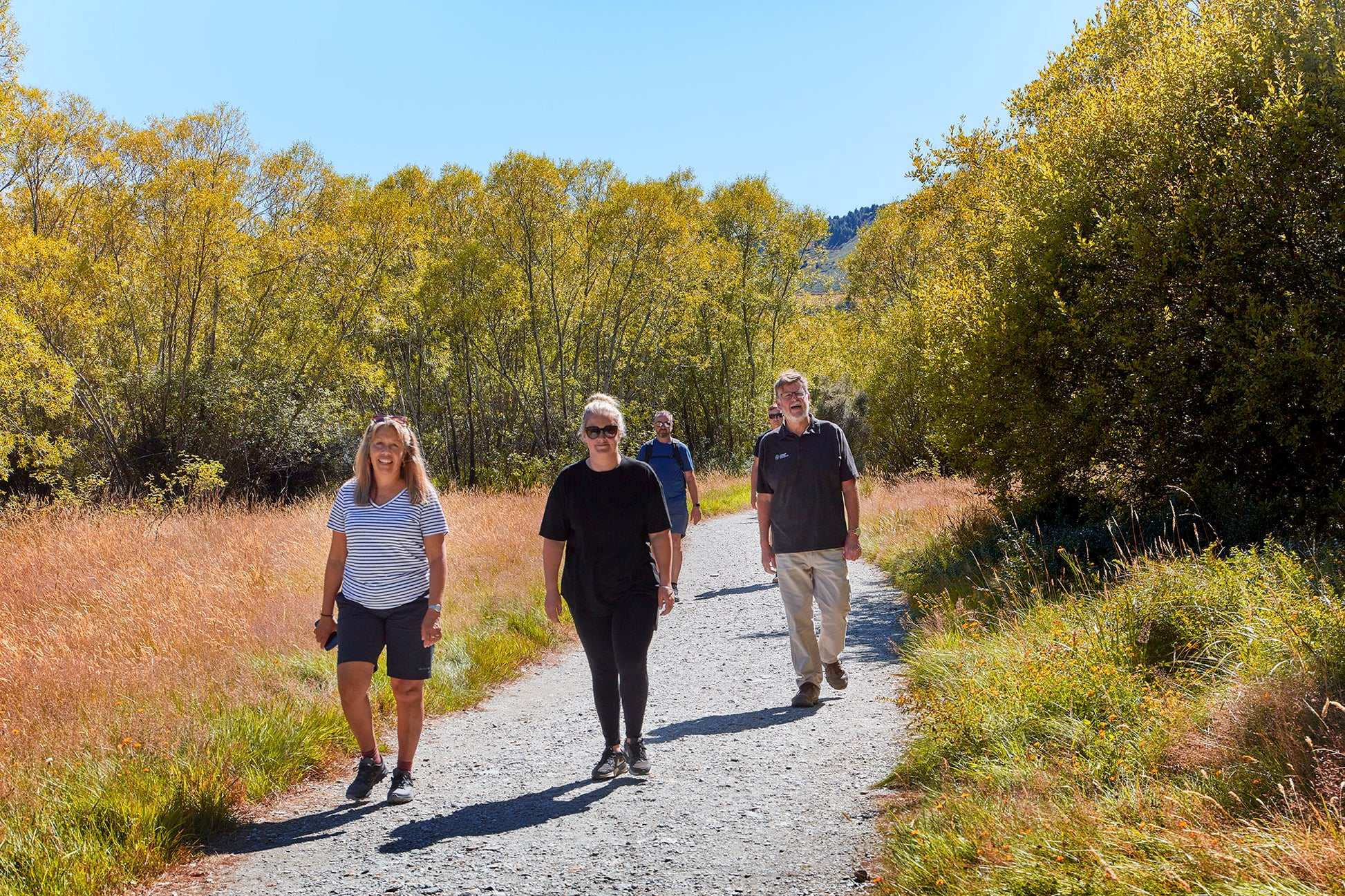 Visitors walking the Glenorchytrack with local guide on private day trip